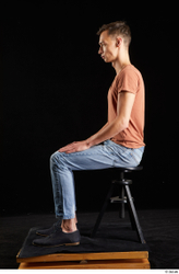 Alessandro Katz  black shoes blue jeans brown t shirt casual dressed sitting whole body  jpg